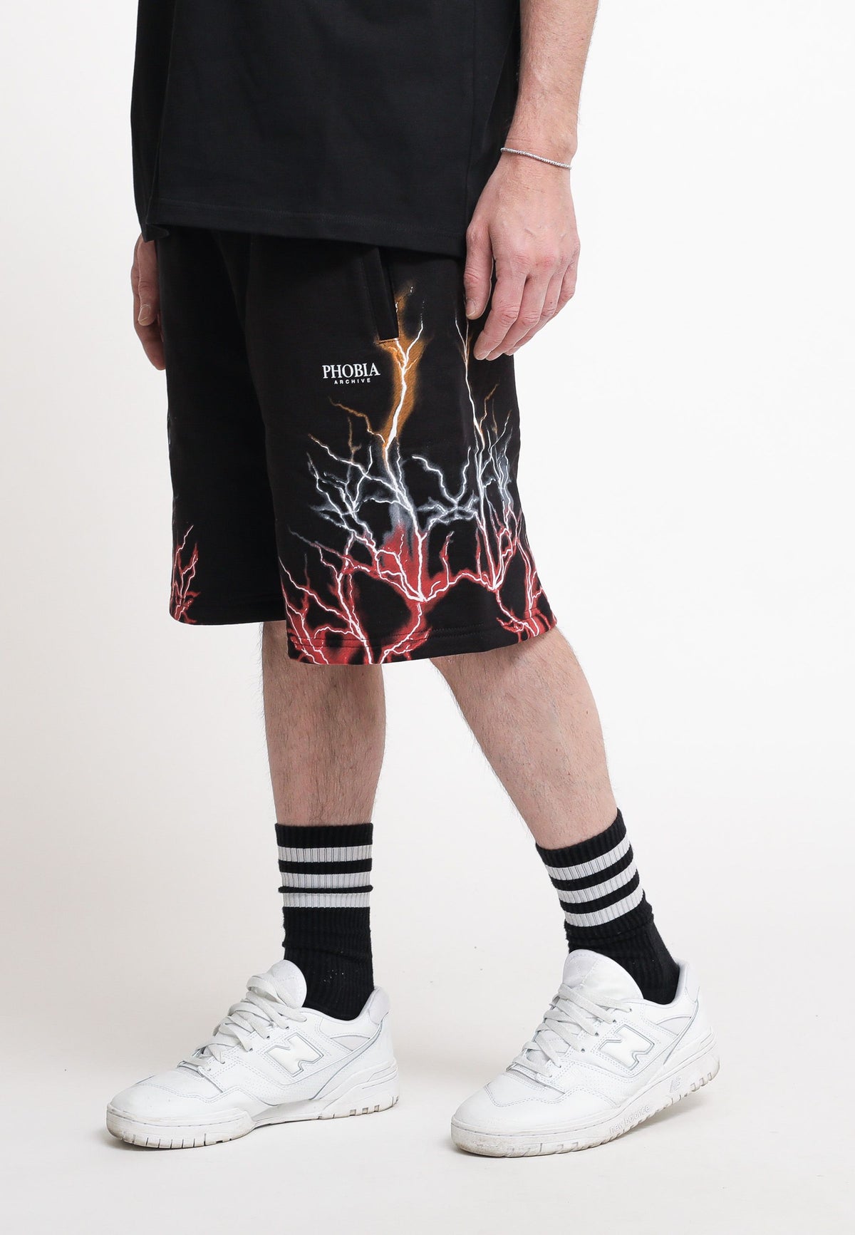 Black shorts with red, grey, and orange lightning. — 1