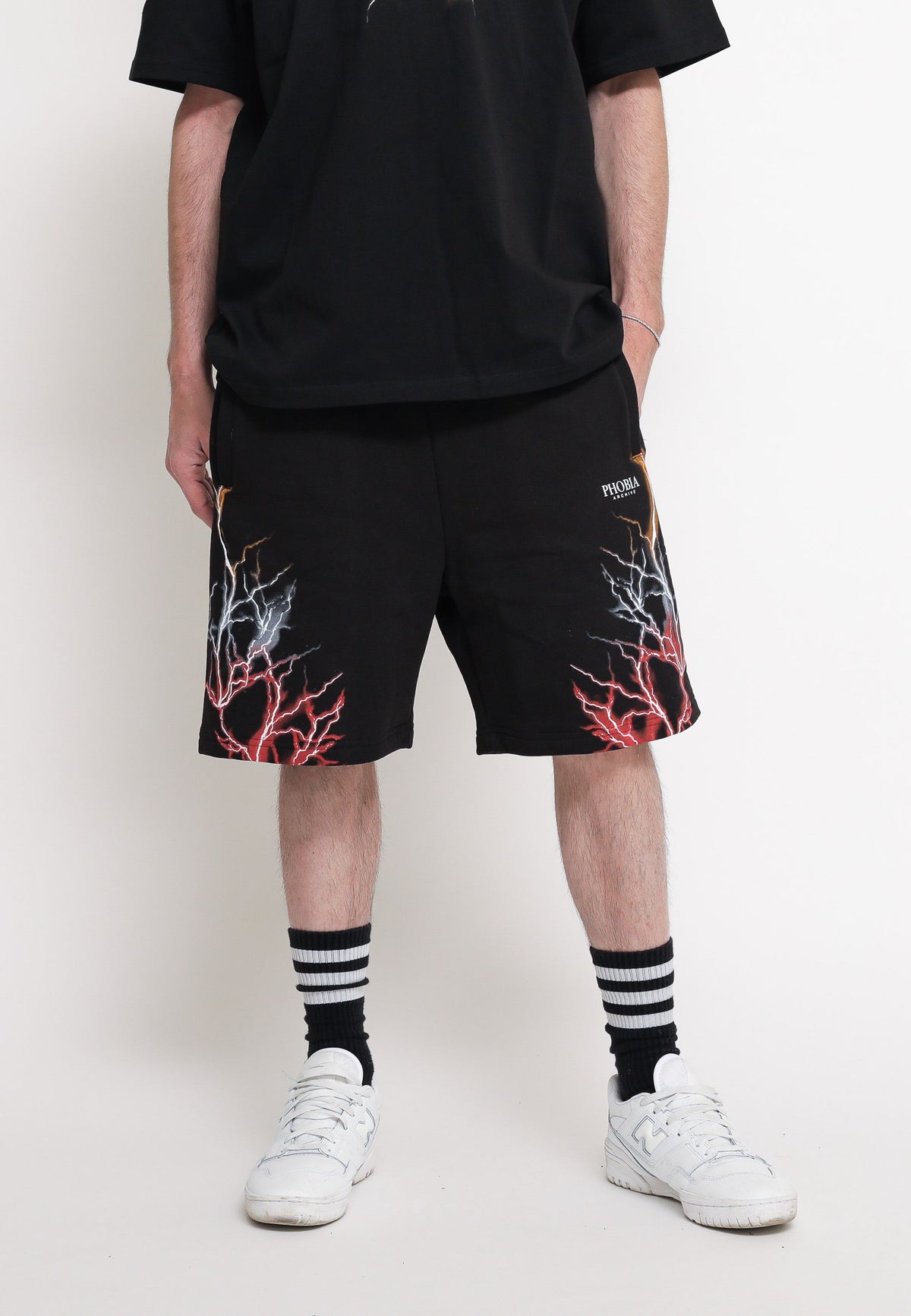 Black shorts with red, grey, and orange lightning. — 2