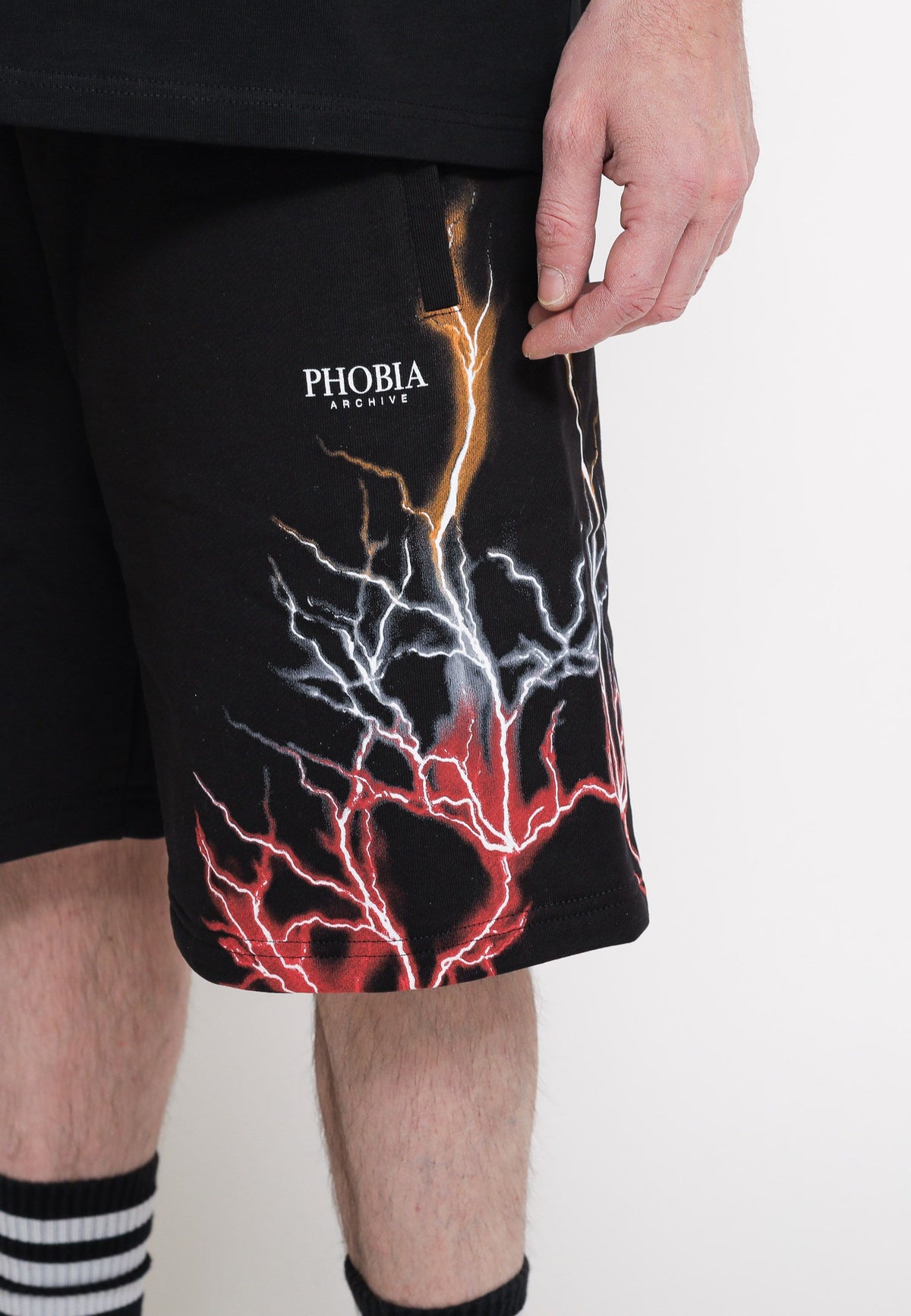 Black shorts with red, grey, and orange lightning. — 5